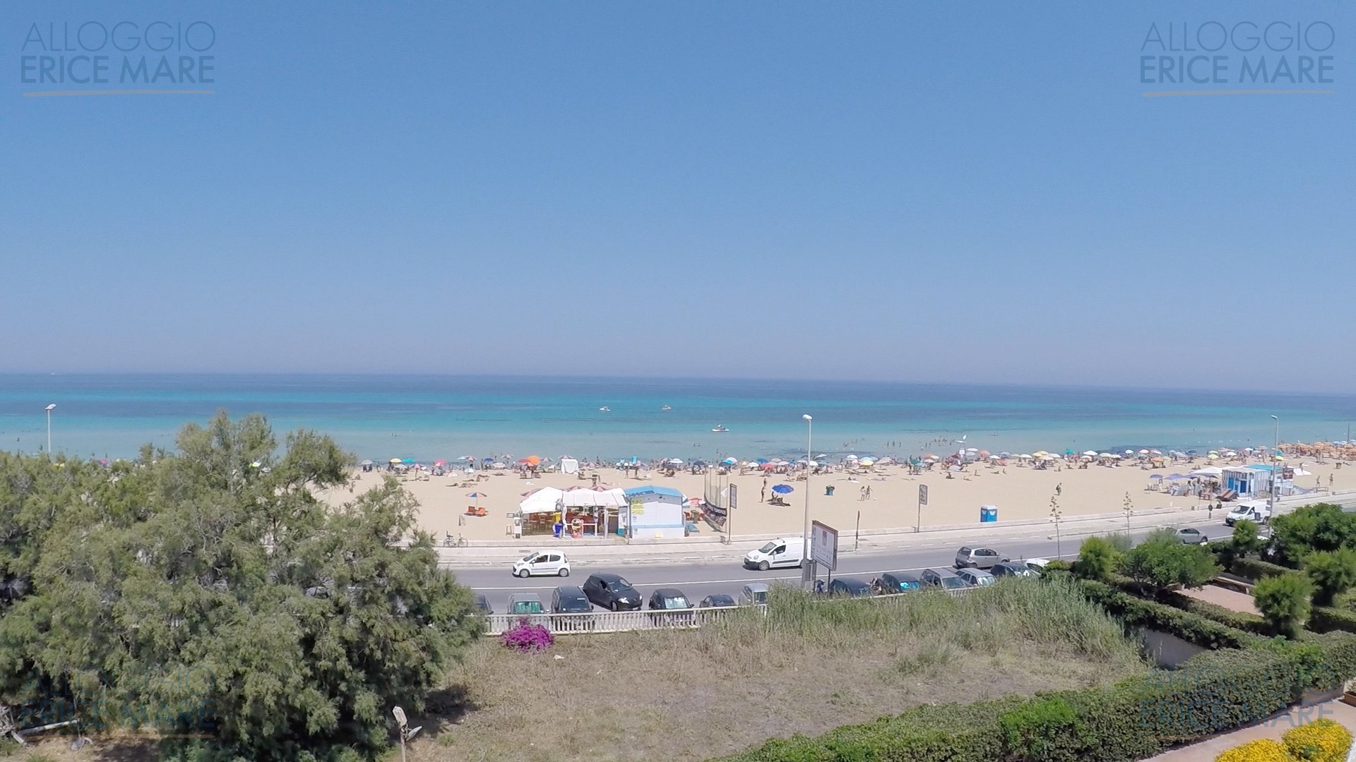 Vista panoramica sulla spiaggia di San Giuliano a Erice, con il mare turchese e la strada costiera in primo piano